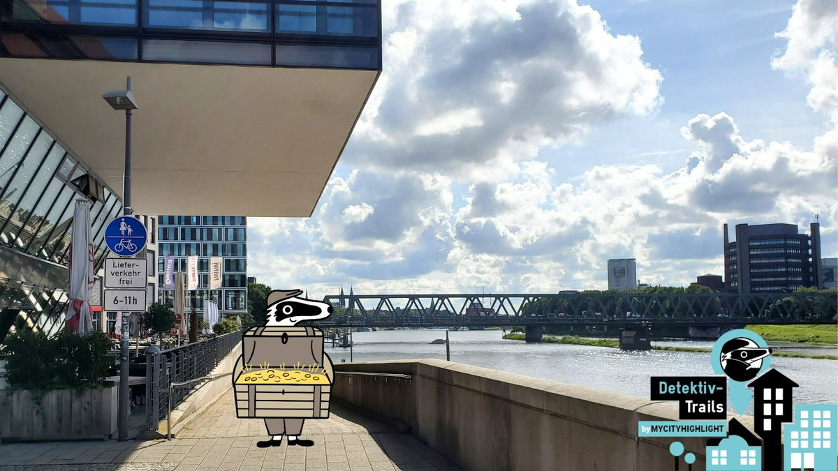 Detektiv-Dachs präsentiert die Schatztruhe an der Promenade der Weser