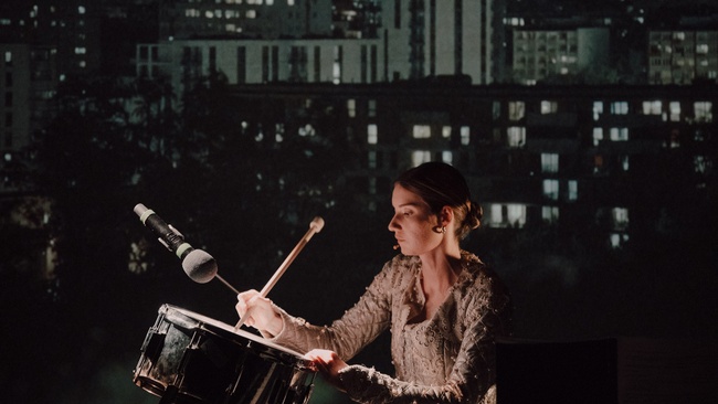 She stands in the middle of the battlefield